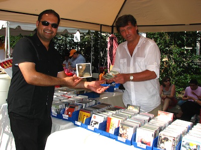 Behzad Habibzai making a purchase from fellow flamenco guitarist Guillermo Christie at the Flamenco Connection caseta