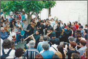 Tzigani musicians play to a large crowd in the street